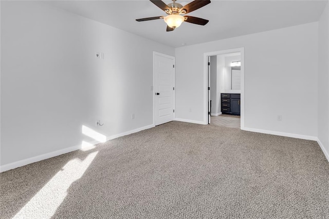 unfurnished bedroom featuring ceiling fan, ensuite bathroom, and carpet floors