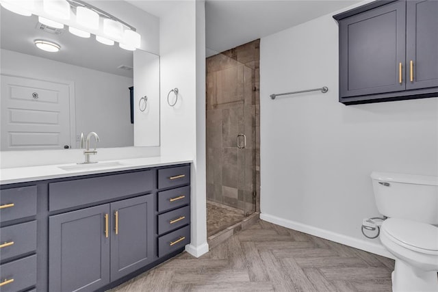 bathroom with a shower with door, vanity, parquet flooring, and toilet