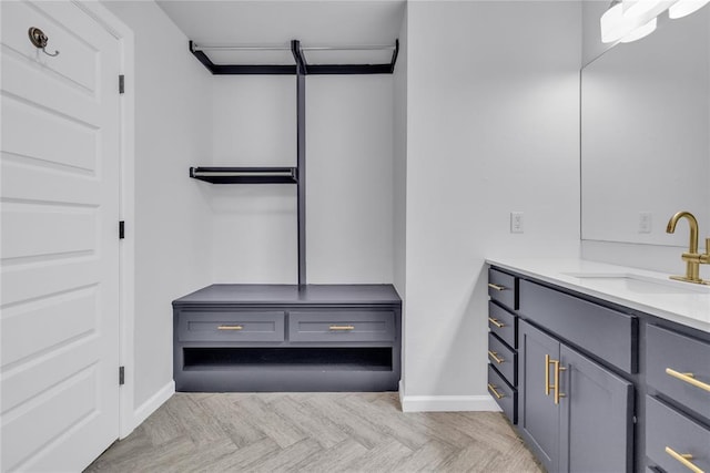 bathroom featuring parquet flooring and vanity