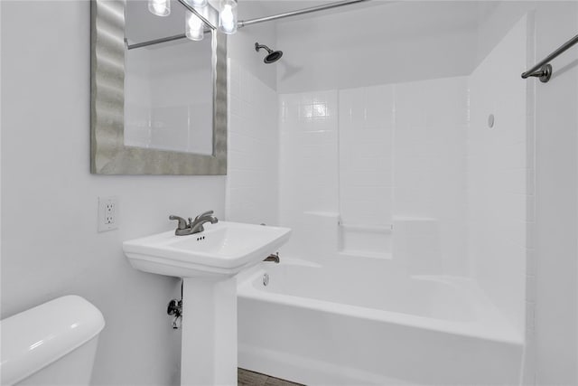 bathroom featuring shower / washtub combination and toilet