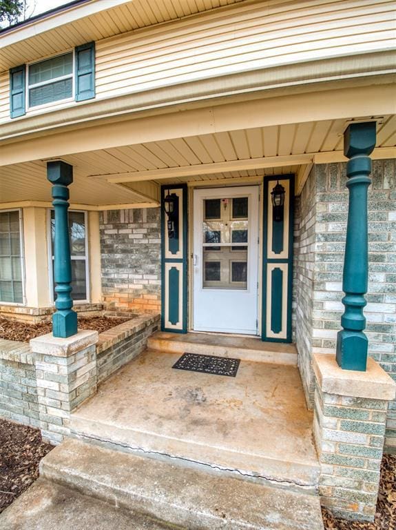 view of exterior entry with a porch