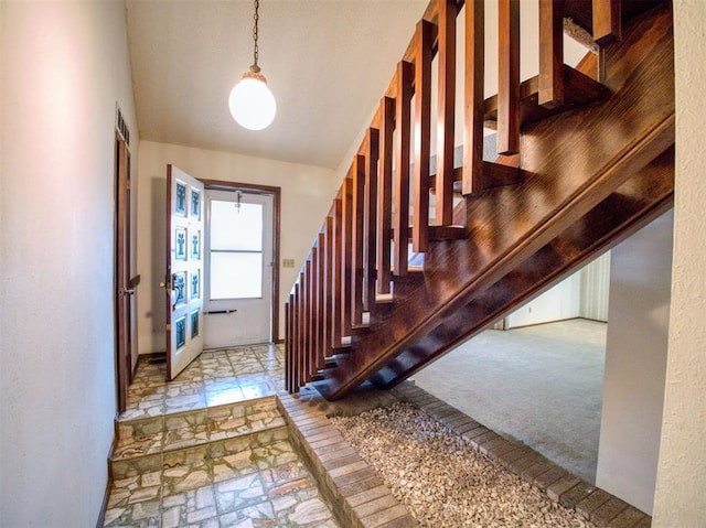 foyer featuring light carpet