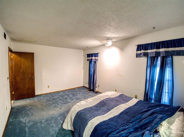 carpeted bedroom with a textured ceiling