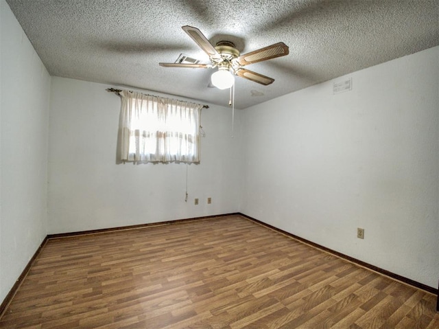 unfurnished room featuring ceiling fan, hardwood / wood-style floors, and a textured ceiling