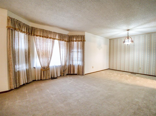7318 Hummingbird Cir, Oklahoma City, OK 73162 - carpeted empty room featuring a textured ceiling and wallpapered walls