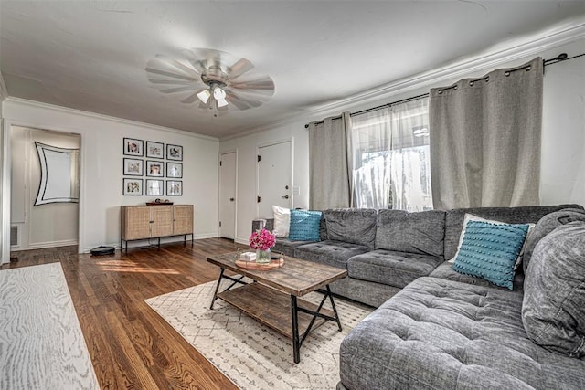 living room featuring dark hardwood / wood-style flooring, ornamental molding, and ceiling fan