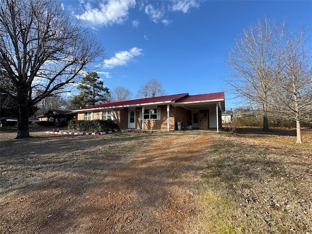 ranch-style house featuring a carport