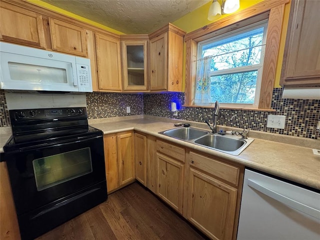 kitchen with sink, a textured ceiling, dark hardwood / wood-style floors, white appliances, and backsplash