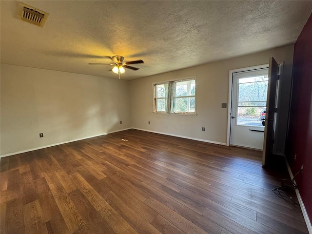 spare room featuring ceiling fan, dark hardwood / wood-style floors, and a textured ceiling