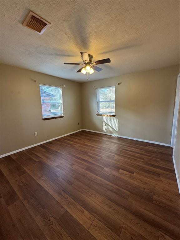 unfurnished room featuring dark hardwood / wood-style flooring, a textured ceiling, and ceiling fan