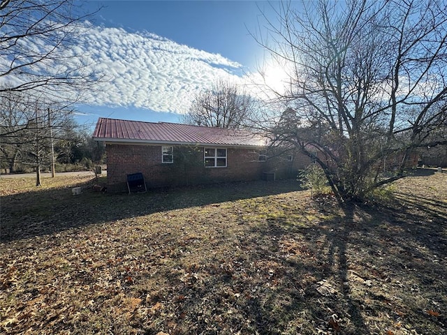 view of side of home with a yard