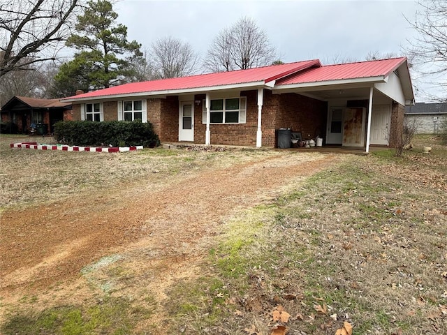 ranch-style house featuring a carport and a front lawn