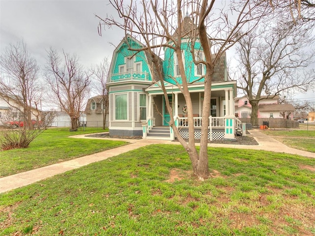 view of front of house featuring covered porch and a front lawn