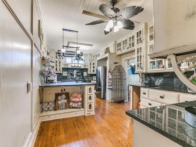 506 S Evans Ave, El Reno, OK 73036 - kitchen with pendant lighting, stainless steel refrigerator, white cabinetry, tasteful backsplash, and light hardwood / wood-style floors