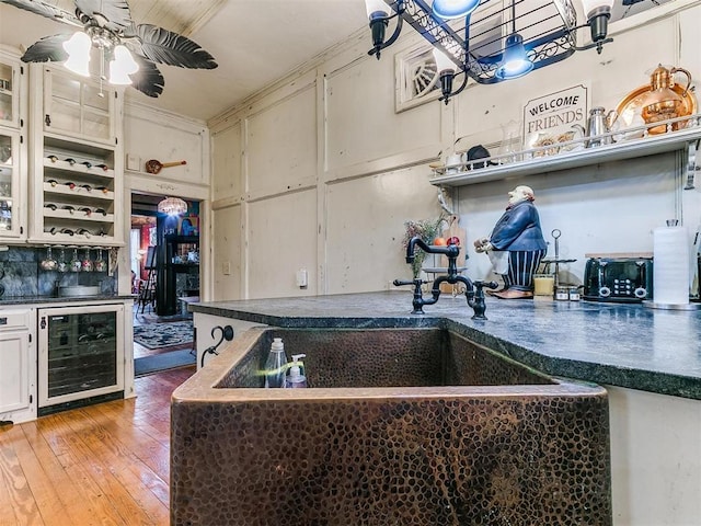 506 S Evans Ave, El Reno, OK 73036 - kitchen featuring sink, white cabinets, wine cooler, hardwood / wood-style flooring, and ceiling fan