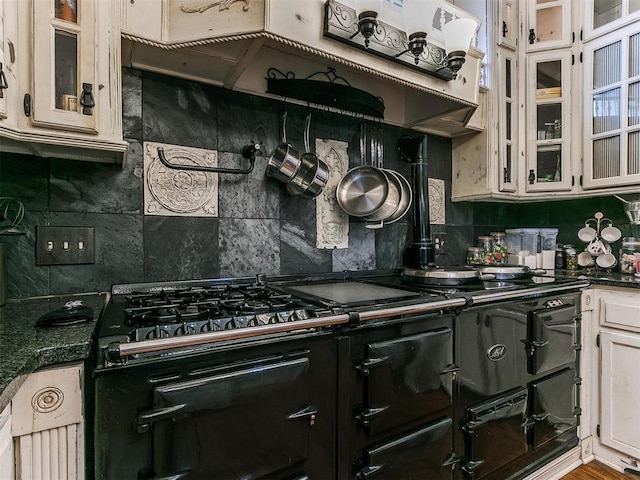 506 S Evans Ave, El Reno, OK 73036 - kitchen with dark stone counters, decorative backsplash, and white cabinets