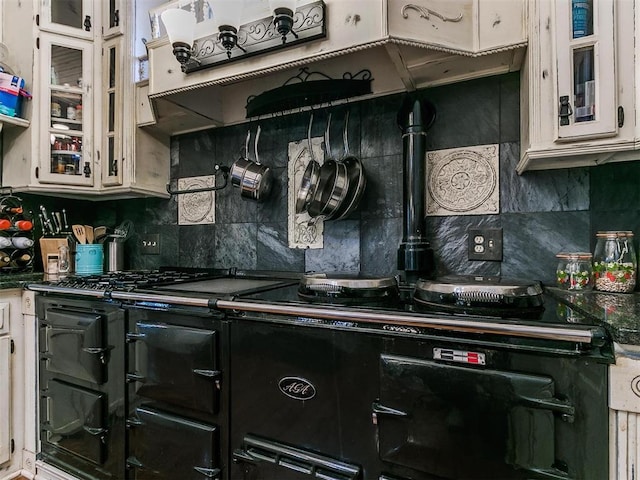 506 S Evans Ave, El Reno, OK 73036 - kitchen with white cabinetry, tasteful backsplash, and range