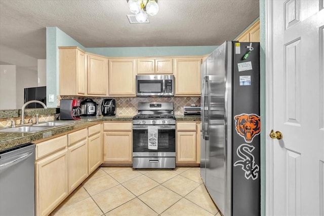 kitchen with light tile patterned flooring, sink, light brown cabinets, stainless steel appliances, and decorative backsplash