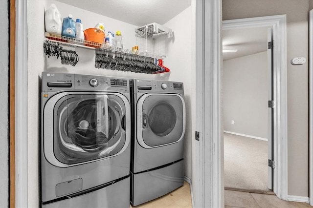 laundry room featuring independent washer and dryer and light carpet