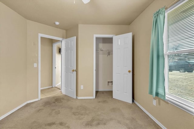 unfurnished bedroom featuring a closet and light carpet