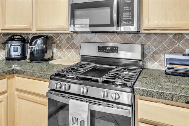 kitchen featuring light brown cabinetry, tasteful backsplash, and appliances with stainless steel finishes