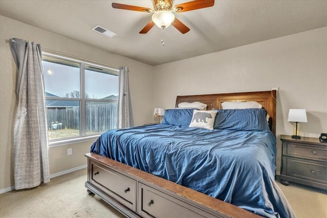 bedroom featuring light carpet and ceiling fan