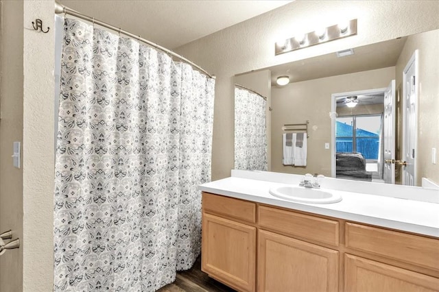 bathroom with vanity, hardwood / wood-style floors, and a shower with curtain