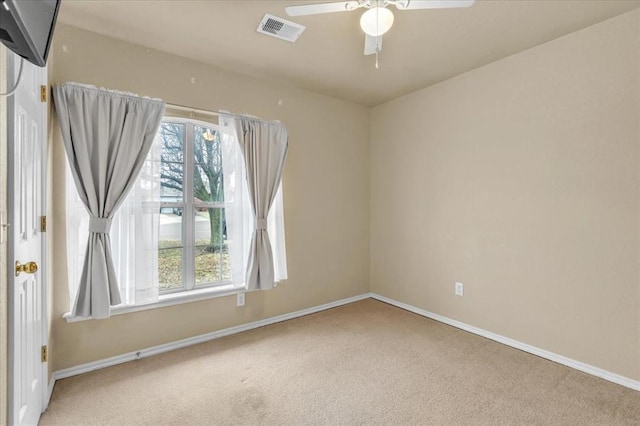 unfurnished room with ceiling fan, plenty of natural light, and carpet floors