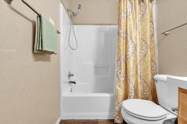 bathroom with shower / tub combo and toilet