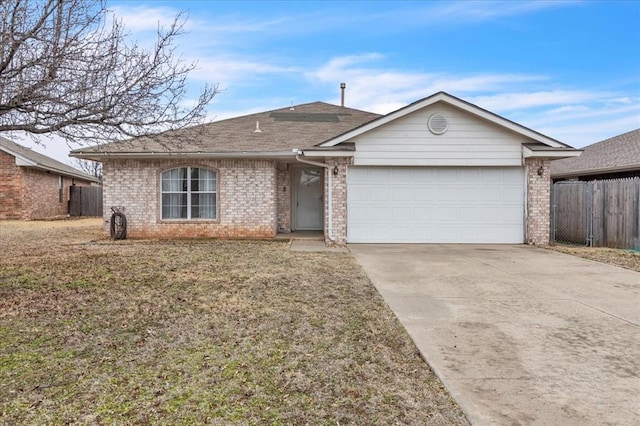 single story home featuring a garage and a front yard