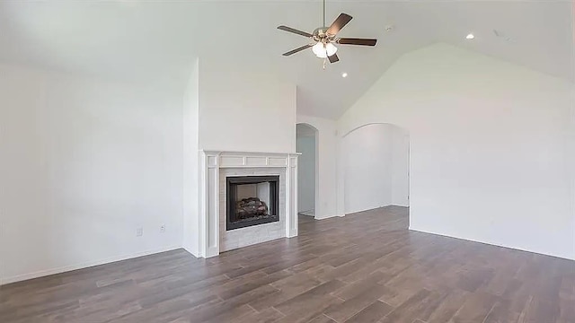 unfurnished living room with a fireplace, high vaulted ceiling, dark hardwood / wood-style floors, and ceiling fan