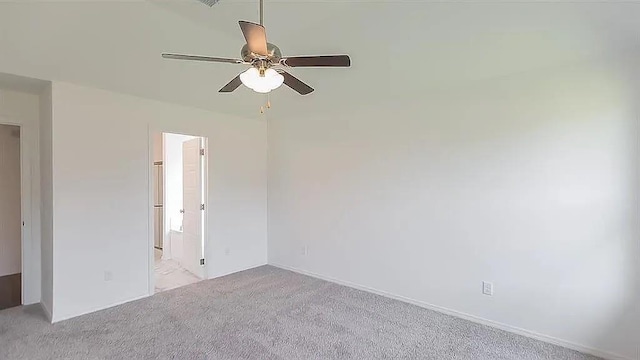 carpeted spare room with ceiling fan