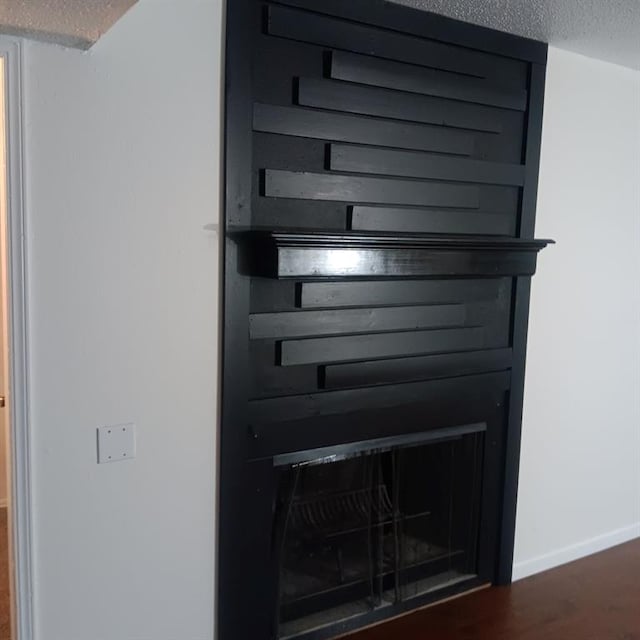 room details with wood-type flooring and a textured ceiling