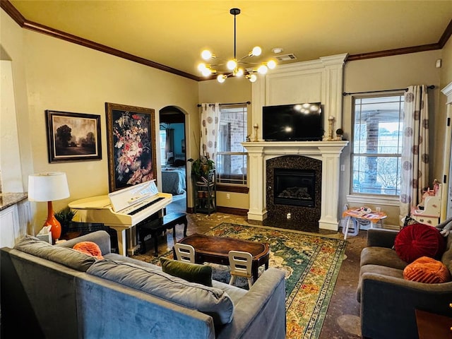 living room with crown molding, a premium fireplace, a chandelier, and a wealth of natural light