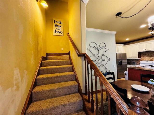 staircase featuring ornamental molding