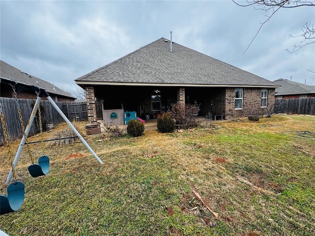 rear view of property with a yard and a patio