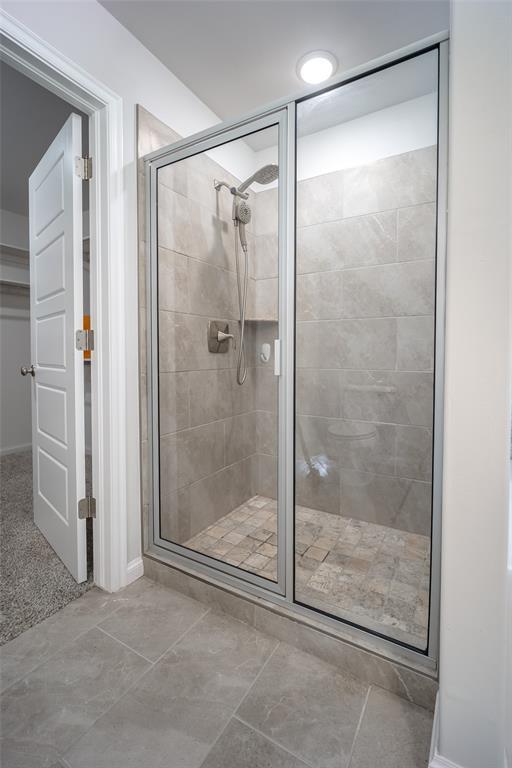 bathroom with a shower with door