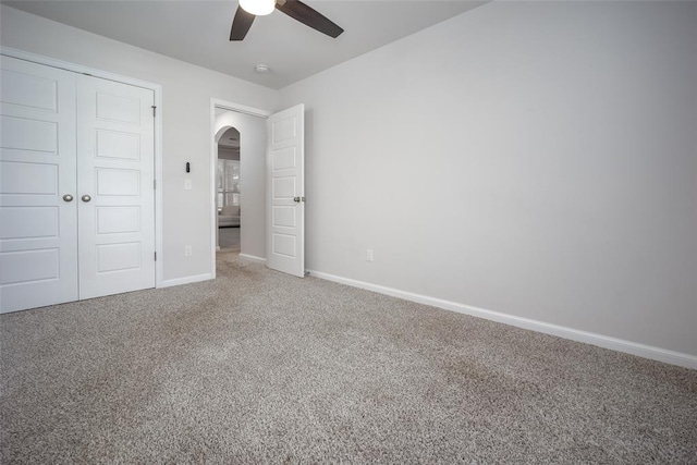 unfurnished bedroom featuring a closet, ceiling fan, and carpet flooring