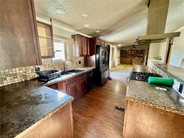 kitchen with island range hood, sink, decorative backsplash, black appliances, and light wood-type flooring