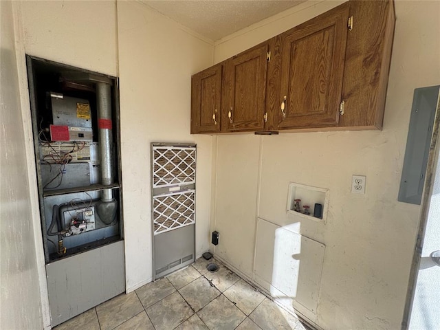 clothes washing area with cabinets, hookup for a washing machine, and light tile patterned floors