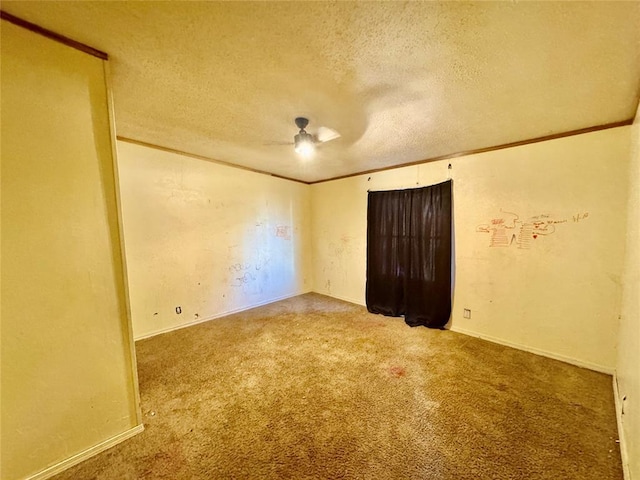 unfurnished room with ceiling fan, ornamental molding, carpet flooring, and a textured ceiling