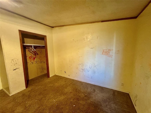 unfurnished bedroom featuring a closet, ornamental molding, carpet, and a textured ceiling