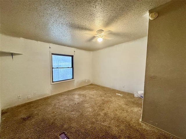 carpeted spare room with a textured ceiling