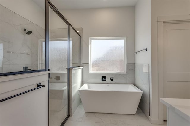 bathroom featuring vanity, shower with separate bathtub, and tile walls