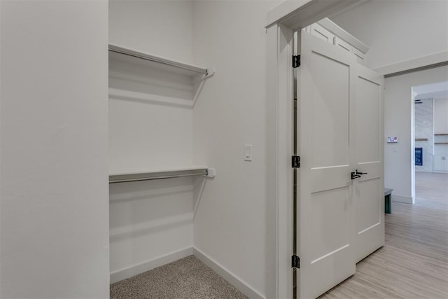 spacious closet featuring light hardwood / wood-style flooring