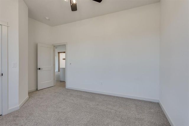 carpeted empty room featuring ceiling fan