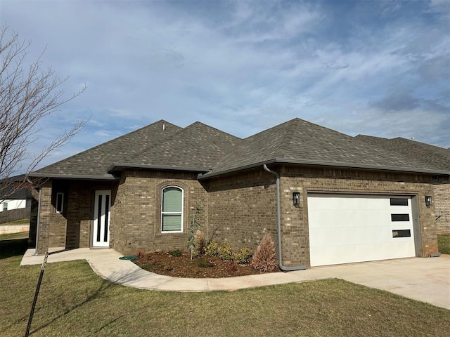 view of front of property featuring a garage and a front lawn