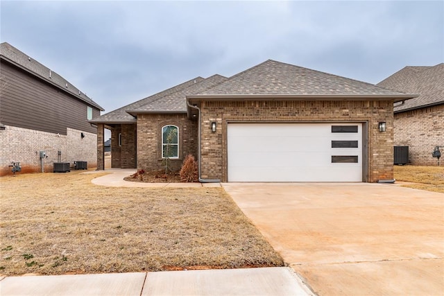 view of front of home with a garage and cooling unit