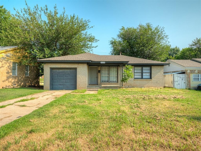 ranch-style house featuring a garage and a front lawn