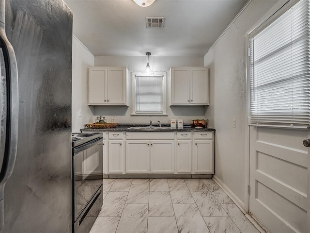 kitchen with white cabinets, sink, hanging light fixtures, and black appliances